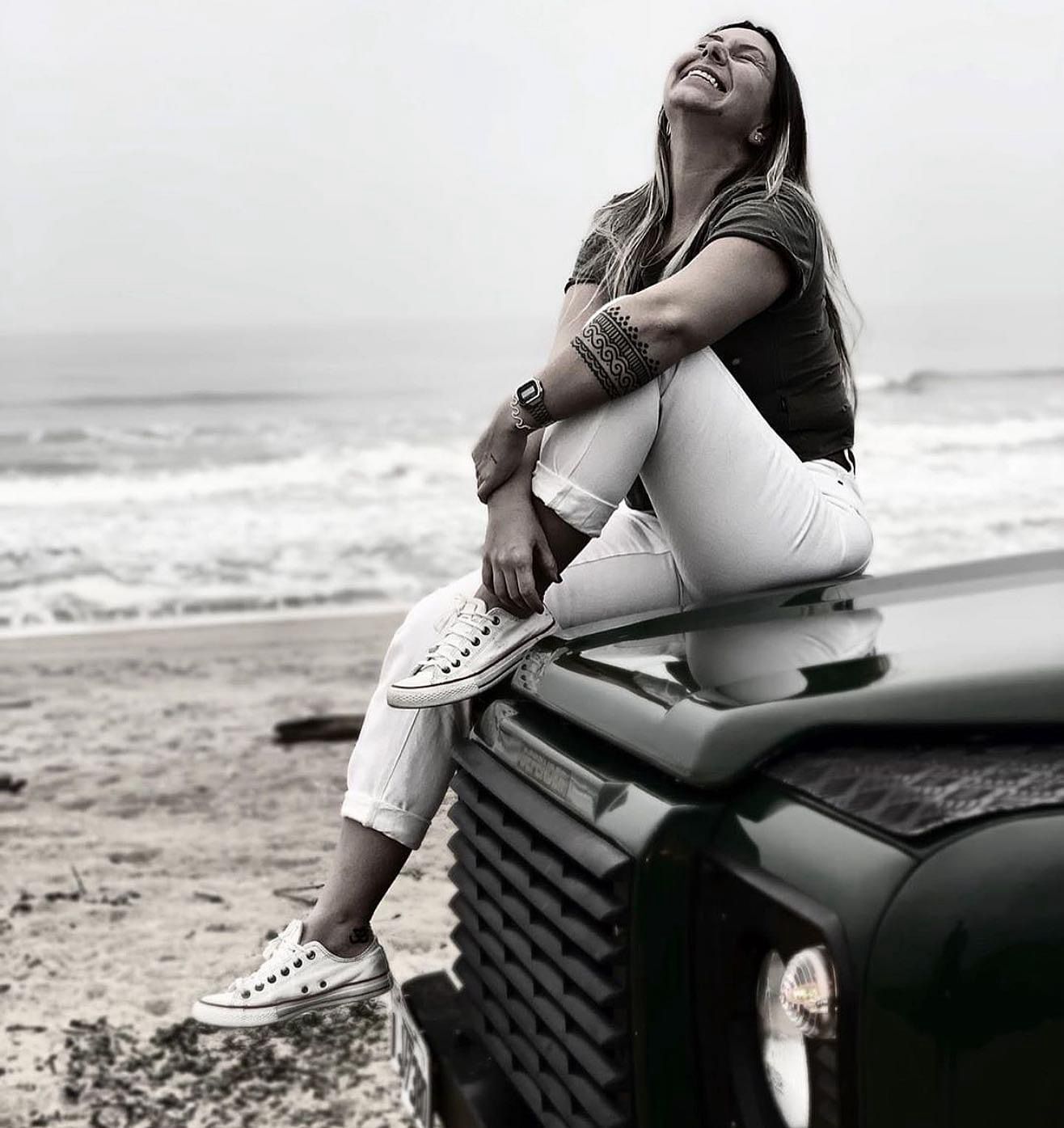 Woman on Defender at the beach, black and white