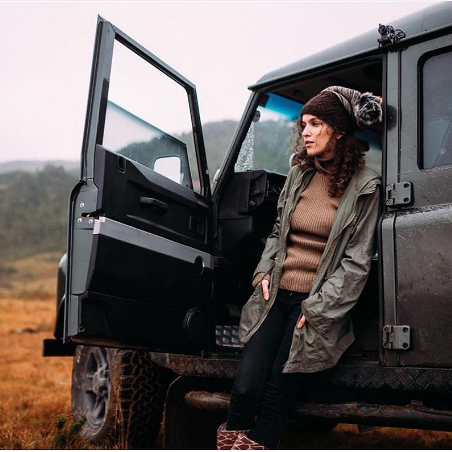 Green Defender 90 with open door in moorland