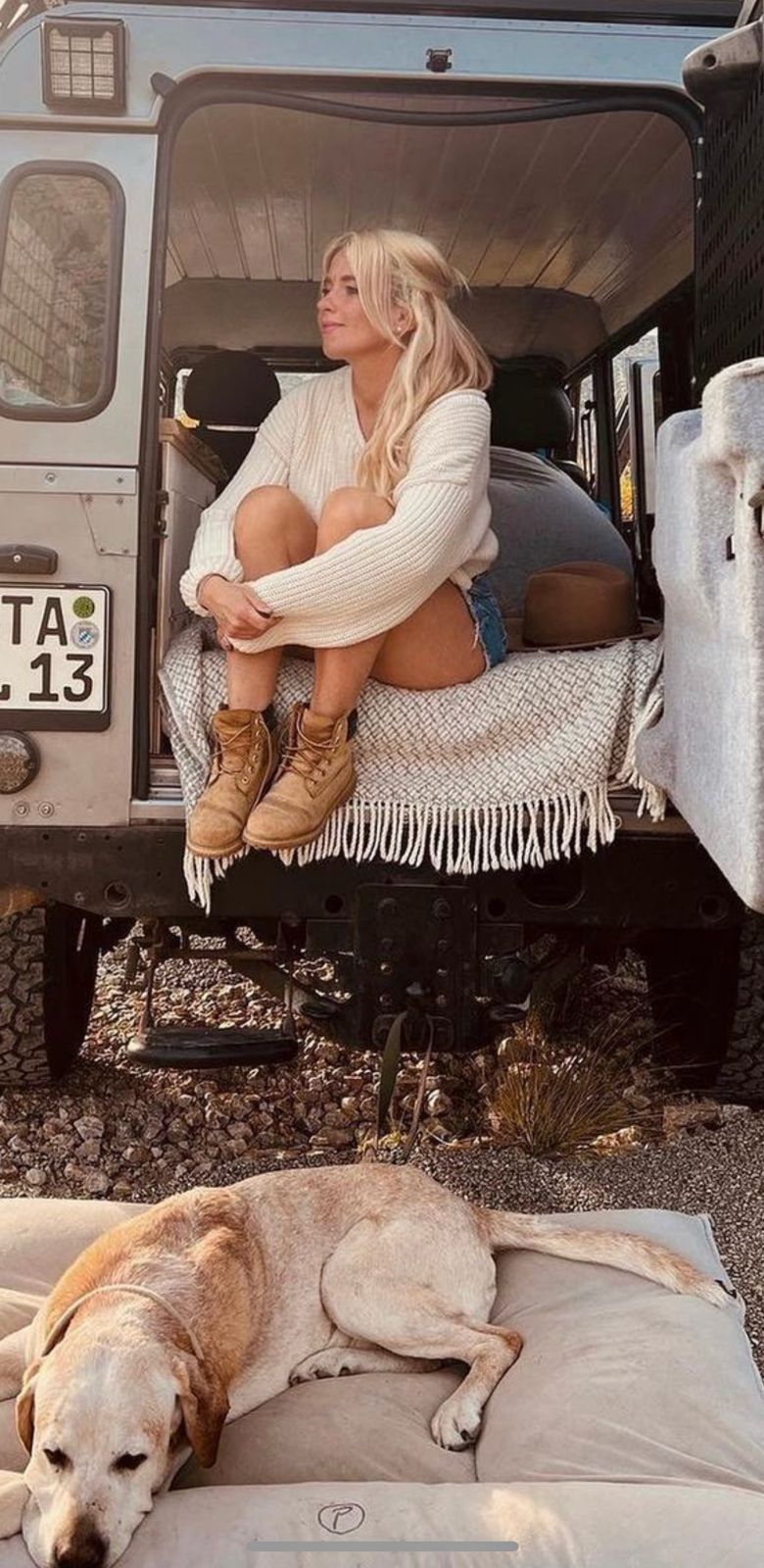 Silver Defender rear open with woman and dog, camper interior