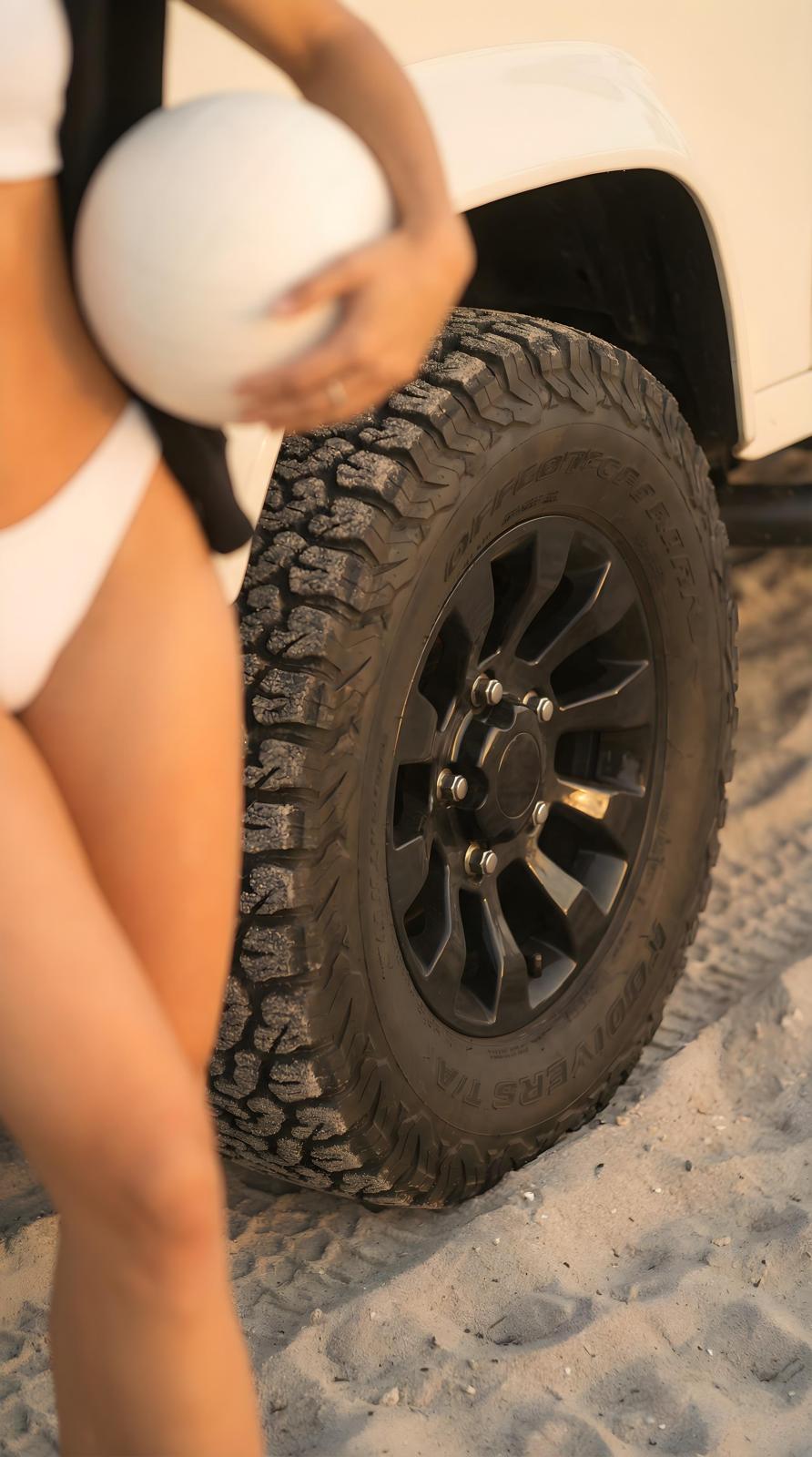 White Defender wheel and beach volleyball